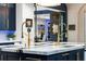 Close up of the kitchen island with dual sinks and gold-tone faucet at 3286 Northside Nw Pkwy # Ph2, Atlanta, GA 30327