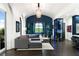 Living room with wine storage, barrel ceiling, blue accent wall, and access to the balcony at 3286 Northside Nw Pkwy # Ph2, Atlanta, GA 30327