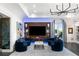 Inviting living room with modern lighting, art pieces, built-in shelving and elegant furnishings at 3286 Northside Nw Pkwy # Ph2, Atlanta, GA 30327