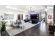 Spacious living room with hardwood floors, statement lighting, a large TV, and access to an outdoor patio at 3286 Northside Nw Pkwy # Ph2, Atlanta, GA 30327