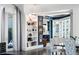 Stylish living room with custom shelving, hardwood floors, access to the balcony, and an adjacent dining area at 3286 Northside Nw Pkwy # Ph2, Atlanta, GA 30327