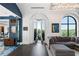 Bright living room featuring a spacious sectional, mosaic floor in the foyer, and arched doorway to the patio at 3286 Northside Nw Pkwy # Ph2, Atlanta, GA 30327