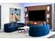 Cozy living room featuring a modern entertainment center and stylish blue sofas at 3286 Northside Nw Pkwy # Ph2, Atlanta, GA 30327