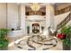Elegant building lobby with a chandelier, staircase, and statement table featuring fresh flowers at 3286 Northside Nw Pkwy # Ph2, Atlanta, GA 30327