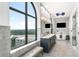 Elegant main bathroom with double vanity, soaking tub, TV, and outside views from a large window at 3286 Northside Nw Pkwy # Ph2, Atlanta, GA 30327