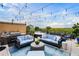 Beautiful rooftop patio featuring comfortable seating, a grill, and city views at 3286 Northside Nw Pkwy # Ph2, Atlanta, GA 30327