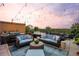 Inviting rooftop patio features comfortable seating, hot tub, outdoor kitchen, and amazing views under festive string lights at 3286 Northside Nw Pkwy # Ph2, Atlanta, GA 30327