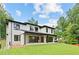 Exterior view of a modern two-story home featuring a covered patio and large windows at 4125 Ashwoody Ne Trl, Brookhaven, GA 30319