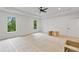 Spacious bedroom featuring two large windows offering natural light and a tray ceiling with a ceiling fan at 4125 Ashwoody Ne Trl, Brookhaven, GA 30319