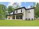 Two-story white brick home with a black trimmed roof, modern windows, and a covered back patio at 4125 Ashwoody Ne Trl, Brookhaven, GA 30319