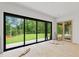 Bright living room with floor-to-ceiling windows overlooking the backyard and access to an outdoor patio at 4125 Ashwoody Ne Trl, Brookhaven, GA 30319