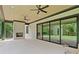 Covered brick patio featuring a fireplace, ceiling fans, and access to the backyard at 4125 Ashwoody Ne Trl, Brookhaven, GA 30319