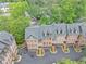 Aerial view of townhomes displaying roof lines, landscaping, and driveway parking at 4222 Rickenbacker Ne Dr # 9, Atlanta, GA 30342