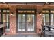 Lovely brick back porch with doors, windows, grill, and outdoor seating, perfect for relaxing and entertaining at 4222 Rickenbacker Ne Dr # 9, Atlanta, GA 30342