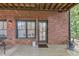 Brick home backyard featuring an outdoor patio with iron chairs, windows, and a door at 4222 Rickenbacker Ne Dr # 9, Atlanta, GA 30342