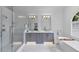 Modern bathroom features a glass shower, double vanity, and soaking tub with stylish fixtures at 4222 Rickenbacker Ne Dr # 9, Atlanta, GA 30342
