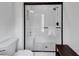 Modern bathroom showcasing a white tiled shower with glass door, bench, and a built-in niche at 4222 Rickenbacker Ne Dr # 9, Atlanta, GA 30342