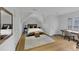Bright bedroom featuring hardwood floors, a cozy bed, and a dedicated desk area at 4222 Rickenbacker Ne Dr # 9, Atlanta, GA 30342