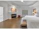 Spacious bedroom featuring a fireplace, hardwood floors, and tray ceiling with ceiling fan at 4222 Rickenbacker Ne Dr # 9, Atlanta, GA 30342