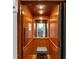 Interior view of a residential elevator with wood paneling and a seating area at 4222 Rickenbacker Ne Dr # 9, Atlanta, GA 30342