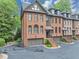 Charming townhome featuring brick facade, private garage, and inviting front steps at 4222 Rickenbacker Ne Dr # 9, Atlanta, GA 30342