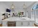 Bright kitchen island with white countertops, stainless steel dishwasher, modern lighting and open layout at 4222 Rickenbacker Ne Dr # 9, Atlanta, GA 30342