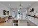 Open-concept kitchen with large island, stainless steel appliances, and elegant pendant lighting at 4222 Rickenbacker Ne Dr # 9, Atlanta, GA 30342