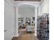 Open-concept living room with columns, wine rack, fireplace, neutral tones, and access to natural light at 4222 Rickenbacker Ne Dr # 9, Atlanta, GA 30342