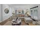Inviting living room with a sectional sofa, modern decor, plantation shutters, and access to the dining area at 4222 Rickenbacker Ne Dr # 9, Atlanta, GA 30342