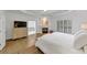 Open Main bedroom showcasing fireplace, light-filled windows and ensuite bathroom at 4222 Rickenbacker Ne Dr # 9, Atlanta, GA 30342