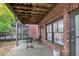 Brick home exterior featuring an outdoor patio with iron chairs and a wooden ceiling at 4222 Rickenbacker Ne Dr # 9, Atlanta, GA 30342