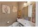 Stylish powder room featuring patterned wallpaper, a modern sink, and decorative artwork at 4222 Rickenbacker Ne Dr # 9, Atlanta, GA 30342