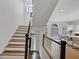 Beautiful staircase with views of kitchen and entryway. The stairs have wooden treads at 4222 Rickenbacker Ne Dr # 9, Atlanta, GA 30342