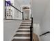 Modern staircase with wooden treads, white risers, and a black handrail at 4222 Rickenbacker Ne Dr # 9, Atlanta, GA 30342