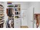 Organized walk-in closet with shelving, hanging rods, and drawers for efficient storage at 4222 Rickenbacker Ne Dr # 9, Atlanta, GA 30342
