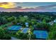 Aerial view of neighborhood tennis courts and a luxury home at 4620 Springdale Ct, Cumming, GA 30041
