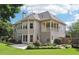 Spacious backyard featuring a covered porch, lush greenery, and a well-maintained lawn for outdoor enjoyment at 4620 Springdale Ct, Cumming, GA 30041