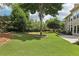 Large backyard with mature trees and lush green grass at 4620 Springdale Ct, Cumming, GA 30041