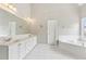 Bright bathroom with double vanity, large mirror and soaking tub at 4620 Springdale Ct, Cumming, GA 30041