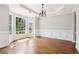 Elegant dining room with hardwood floors, tray ceiling, wainscoting, and large bay window at 4620 Springdale Ct, Cumming, GA 30041