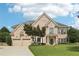 Charming two-story brick home with a well-manicured lawn, two-car garage, and inviting front entrance at 4620 Springdale Ct, Cumming, GA 30041