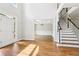 Grand foyer entrance with hardwood floors, staircase, and view into the formal dining room at 4620 Springdale Ct, Cumming, GA 30041