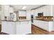 Well-equipped kitchen with white cabinets, granite countertops, a kitchen island, and stainless steel appliances at 4620 Springdale Ct, Cumming, GA 30041