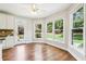 Open-concept kitchen featuring white cabinetry, granite countertops, stainless steel appliances, and hardwood floors at 4620 Springdale Ct, Cumming, GA 30041