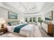 Bright main bedroom featuring a tray ceiling, windows, and art at 4620 Springdale Ct, Cumming, GA 30041