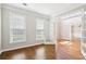 Well-lit office featuring hardwood floors, a window with blinds, and an open doorway to the foyer at 4620 Springdale Ct, Cumming, GA 30041