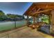 Community pavilion featuring picnic tables, stone columns, and access to a tennis court for outdoor enjoyment at 4620 Springdale Ct, Cumming, GA 30041