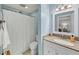 This bathroom features a vanity with granite countertop and a white framed mirror at 2 Arpege Nw Way, Atlanta, GA 30327