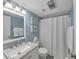 This well-lit bathroom features a vanity with marble countertop and a white framed mirror at 2 Arpege Nw Way, Atlanta, GA 30327