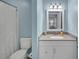 This bathroom features a vanity with granite countertop and a white framed mirror at 2 Arpege Nw Way, Atlanta, GA 30327